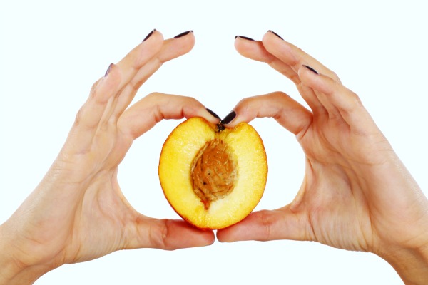 Peach fruit in woman's hands isolated