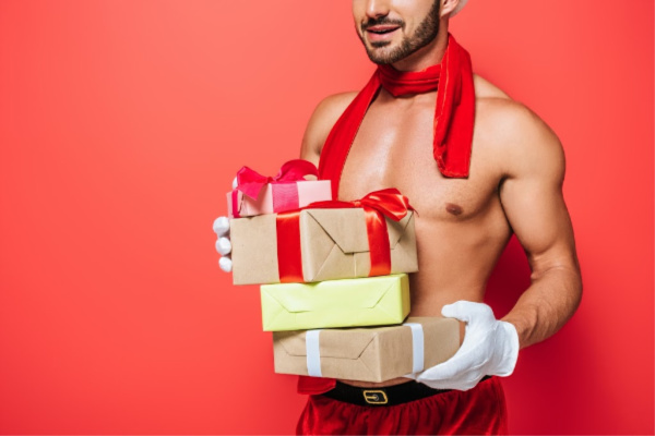 Sexy man holding gifts
