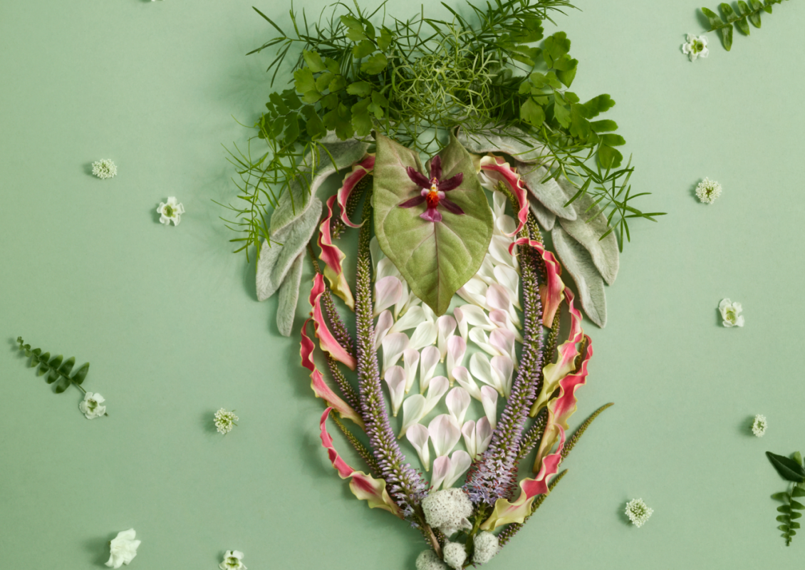 Artistic image of a vulva made of flowers and plants